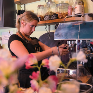 A Jorge member of staff making a coffee