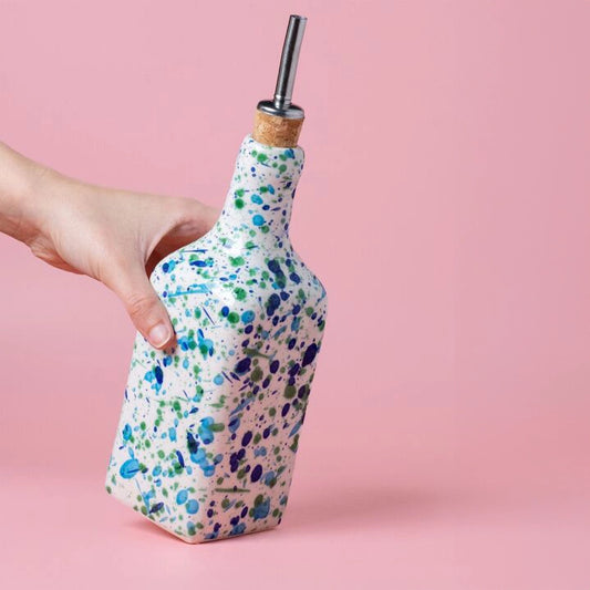 Hand holding Olive Oil Pourer in Coral green and blue