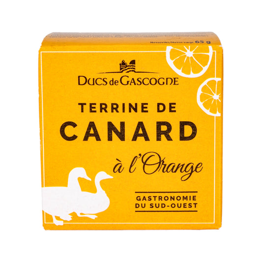 The front of small yellow box with the Duc de Gascogne logo and the title 'Terrine de canard a l'orange' with the outline of ducks and oranges in the corners of the box