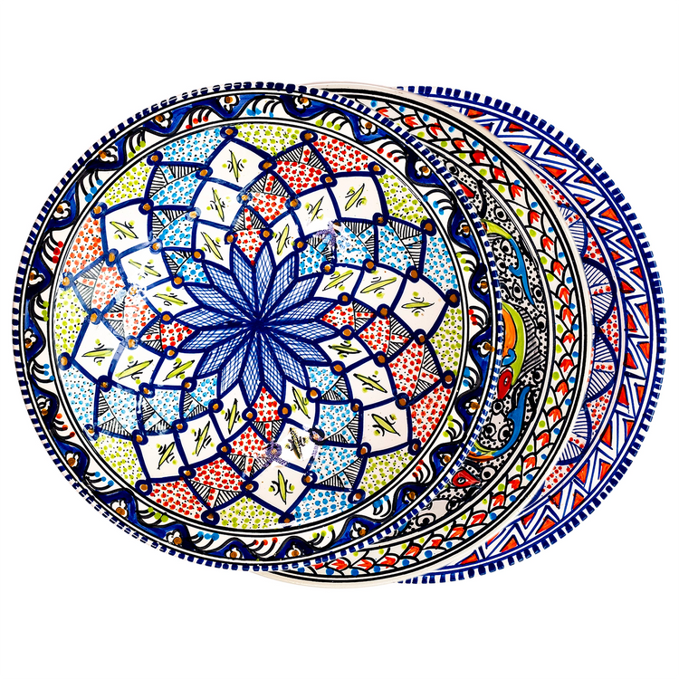 A fanned out stack of three Moroccan style ceramic decorative bowls with vibrant colors of blue, green, red, and white