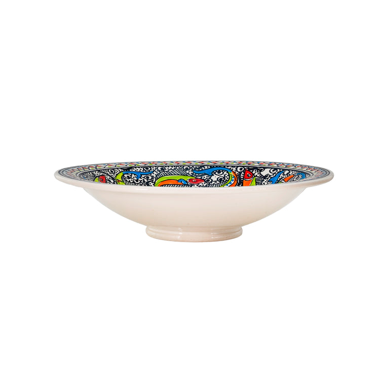 Side angle of an extra large decorative bowl with a colorful, Moroccan-style, marine design. The dish is wide and deep with repeating geometric patterns around the edge