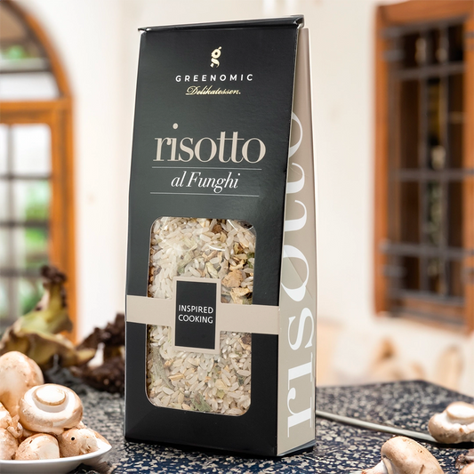 this shows the packet in a lifestyle setting in a kitchen showing a bowl of mushrooms in the foreground of the image.