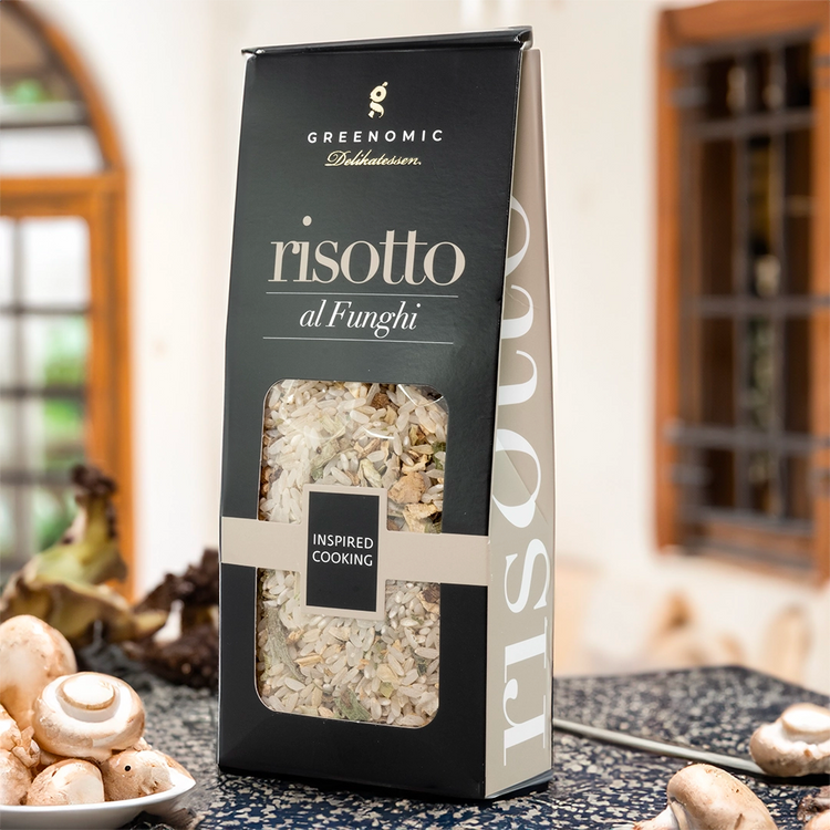 this shows the packet in a lifestyle setting in a kitchen showing a bowl of mushrooms in the foreground of the image.