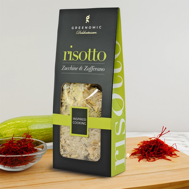 Greenomic Risotto with zucchini and saffron on a table with ingredients
