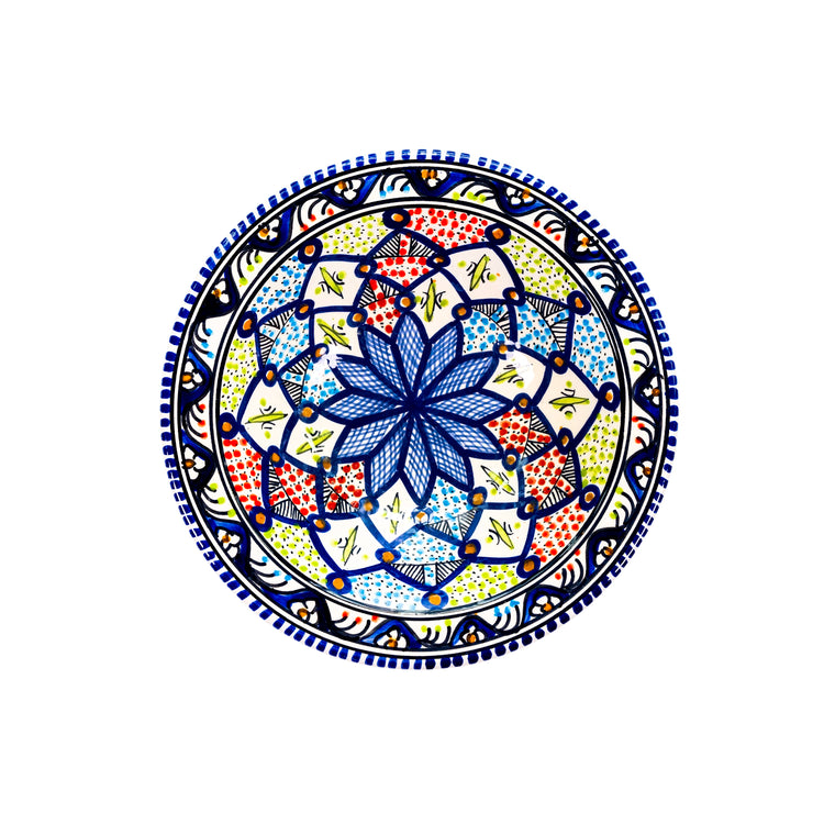 Intricate Moroccan style serving dish in red, blue, green pattern