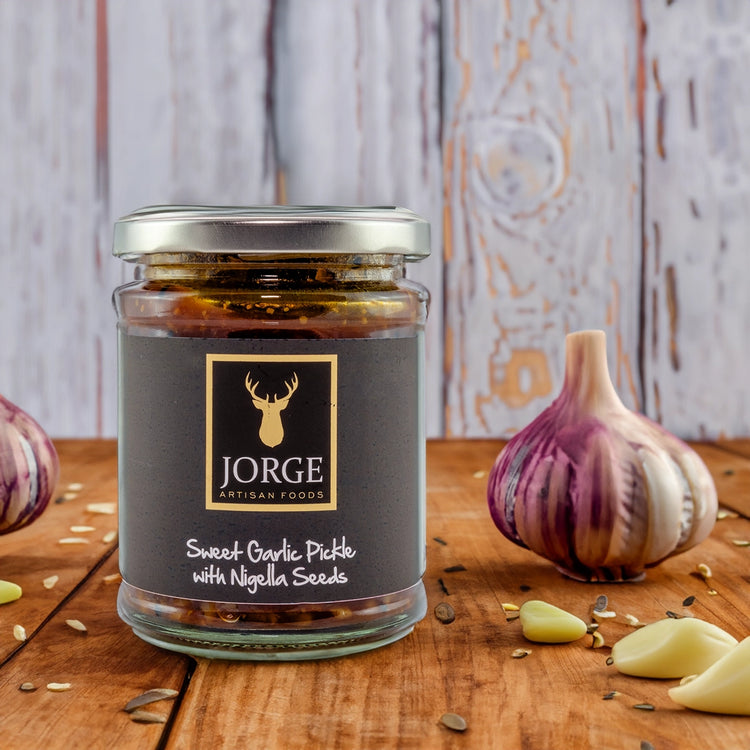 Jorge jar with a backdrop of garlic and seeds