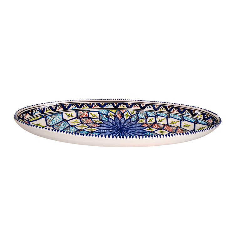 A side view of the oval ceramic dish with a colorful kaleidoscope pattern showing the 6cm depth.