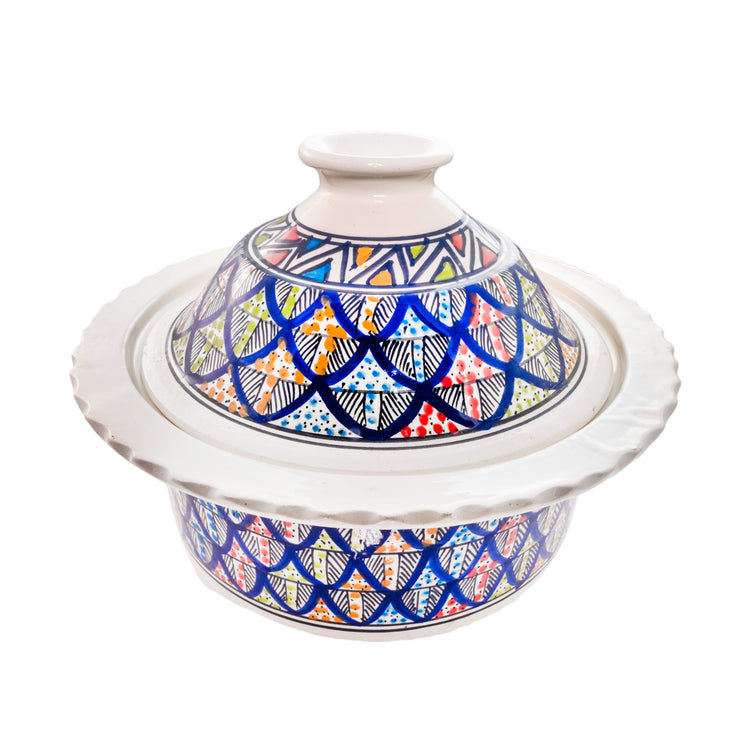 High angle view of ornate ceramic casserole dish showing rim and lid