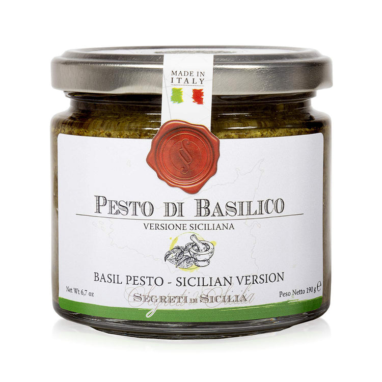 A clear jar with the Frantoi Cutrera logo and the title Pesto di Basilico with a drawing of basil leaves on the jar.