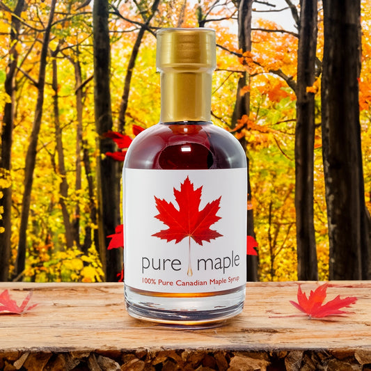 Pure Canadian Maple Syrup bottle on wooden table in forest