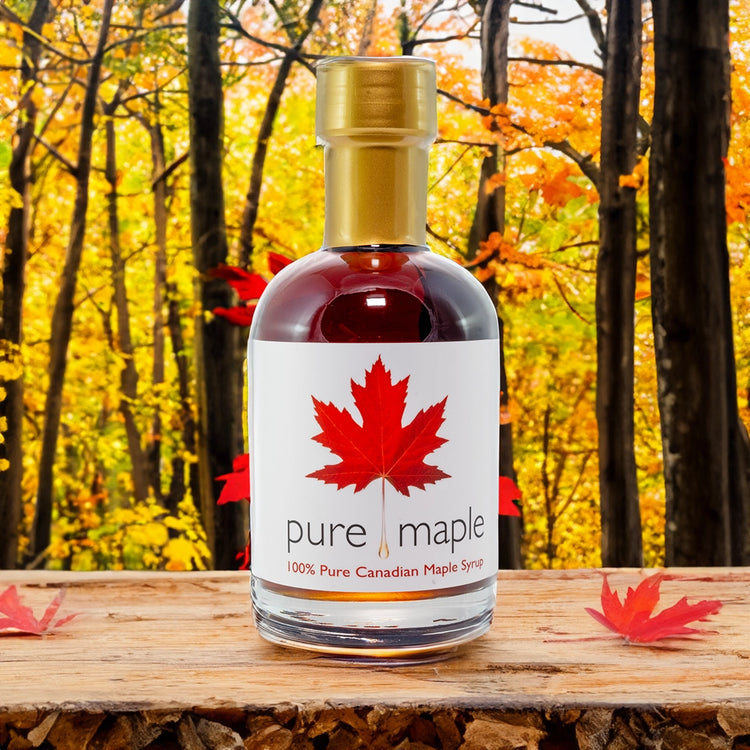 Pure Canadian Maple Syrup bottle on wooden table in forest