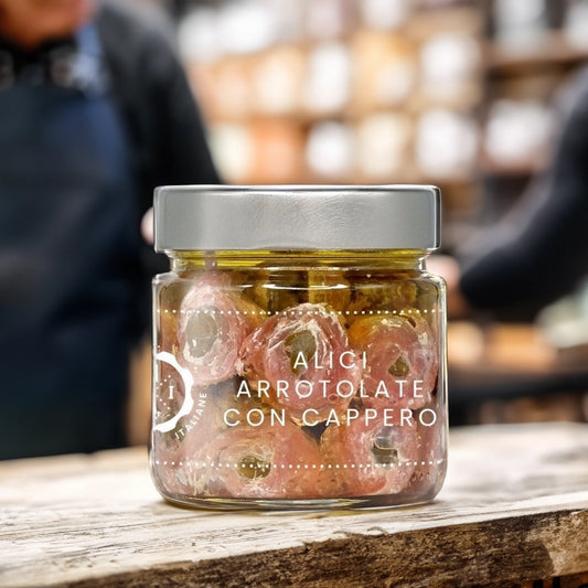 Jar of Rolled Anchovies stuffed with Capers on wooden table in artisan shop
