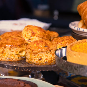 image shows a close up stack of scones on a glass cake stand in the Jorge's cafe.