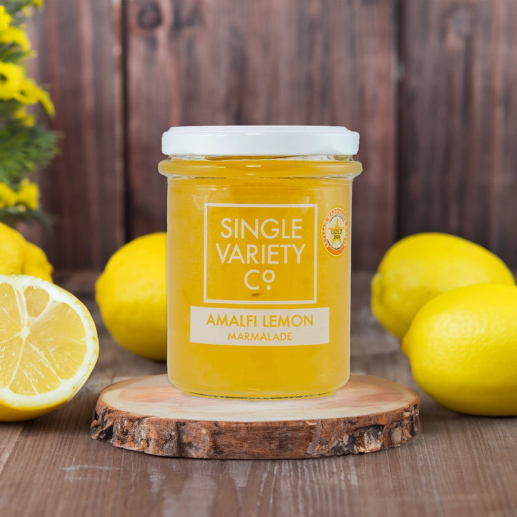 Single Variety C lemon marmalade on wooden table with fresh lemons