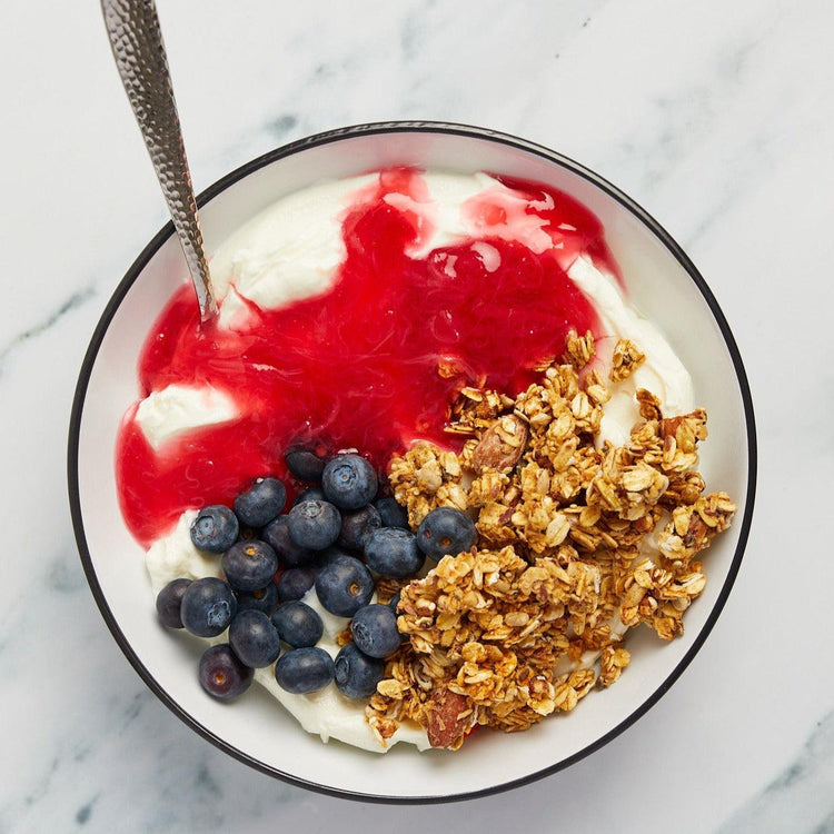 Jar of Single Variety Harbinger Rhubarb Preserve in bowl with granola and yoghurt