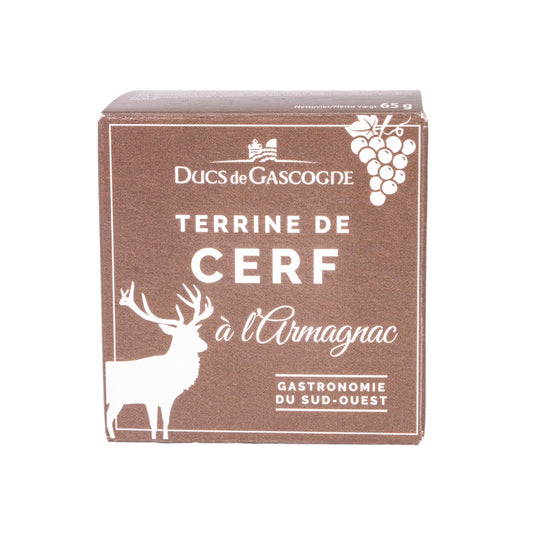 Front view of a brown cardboard box featuring a deer and grapes. The label reads "Ducs de Gascogne Terrine de Cerf à l'Armagnac Gastronomie du Sud-Ouest" in French, which translates to "Dukes of Gascony Deer Terrine with Armagnac Gastronomy of the Southwest."