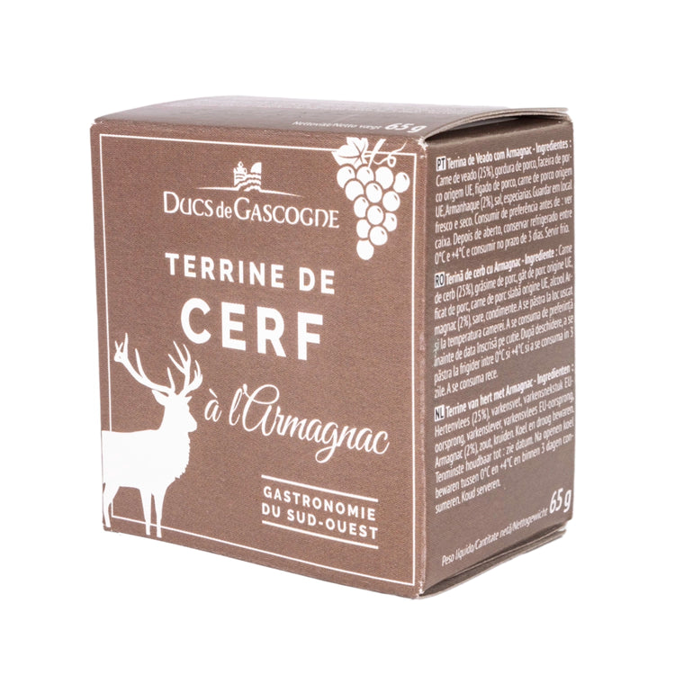 A brown cardboard box featuring a deer and grapes. The label reads "Ducs de Gascogne Terrine de Cerf à l'Armagnac Gastronomie du Sud-Ouest" in French, which translates to "Dukes of Gascony Deer Terrine with Armagnac Gastronomy of the Southwest."