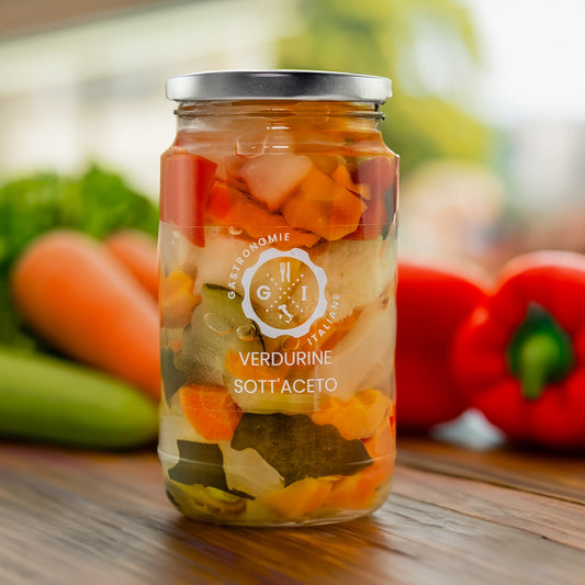 Jar of pickled veg on a wooden table surrounded by veg