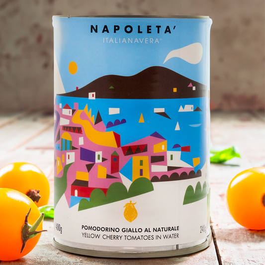 Yellow cherry tomatoes canned with fresh tomatoes scattered on table