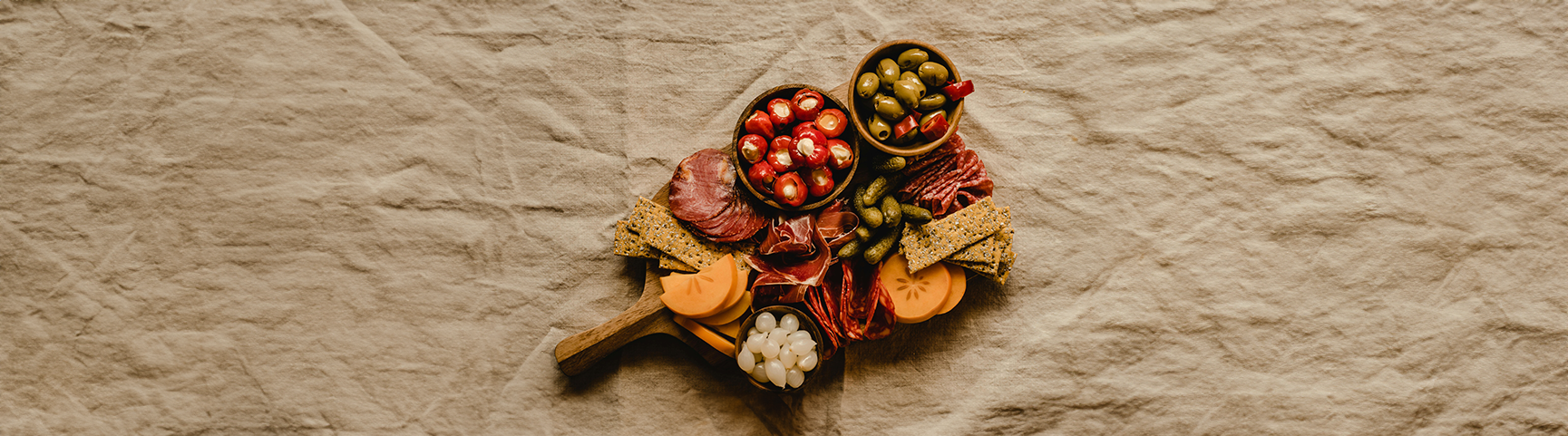 Display of antipasti board with olives and other food items 