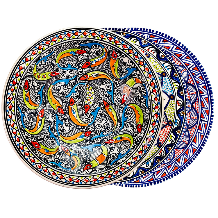 A fanned out stack of three Moroccan style ceramic decorative bowls with  vibrant colors of blue, green, red, and white