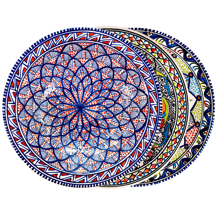 A fanned out stack of three Moroccan, sunburst-style ceramic decorative bowls with  vibrant colors of blue, green, red, and white