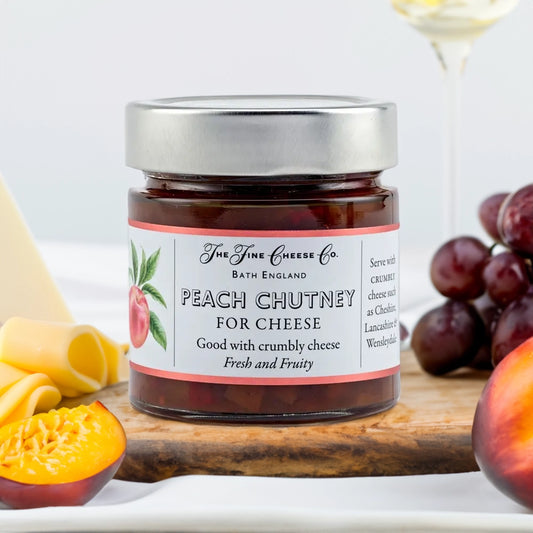 The Fine Cheese Company Peach Chutney jar with fresh peaches, grapes and cheese