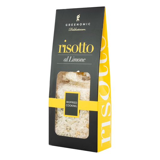 image shows a black packet with the Greenomic logo with a clear window showing the risotto rice with the title risotto al limone