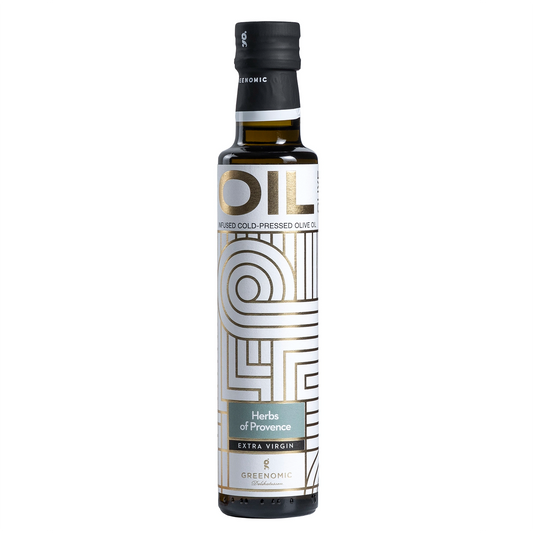 A bottle of Greenomic Herbs of Provence Extra Virgin Olive Oil. The bottle is clear with a black cap and a white and gold label