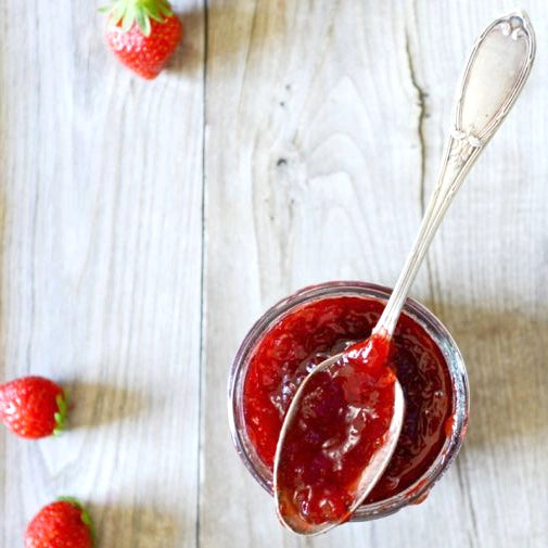 La Cour d'Orgères strawberry jam jar with spoon on table