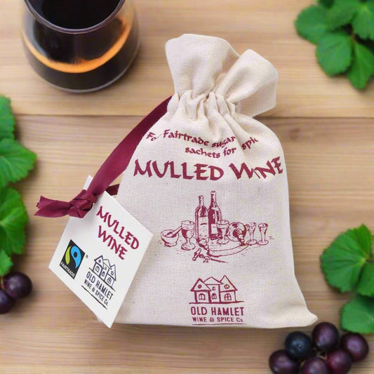 Bag of mulled wine on table with grapes around it