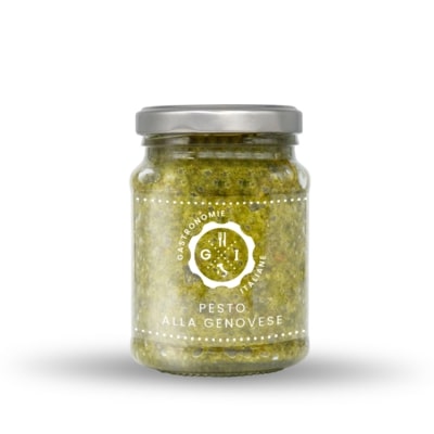 Jar of pesto on white background