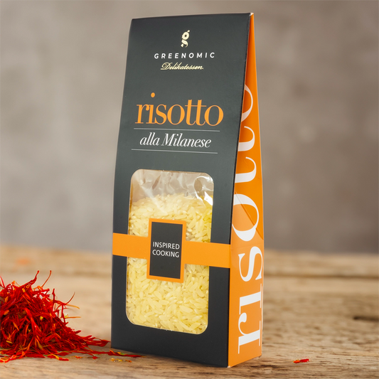 Greenomic Risotto alla Milanese on a table with sprinkle of saffron