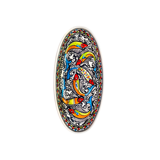 An oblong ceramic dish featuring a colorful design of fish swimming among bubbles and waves. The fish are depicted in various shades of blue, green, orange, and red. The background of the dish is white with intricate patterns